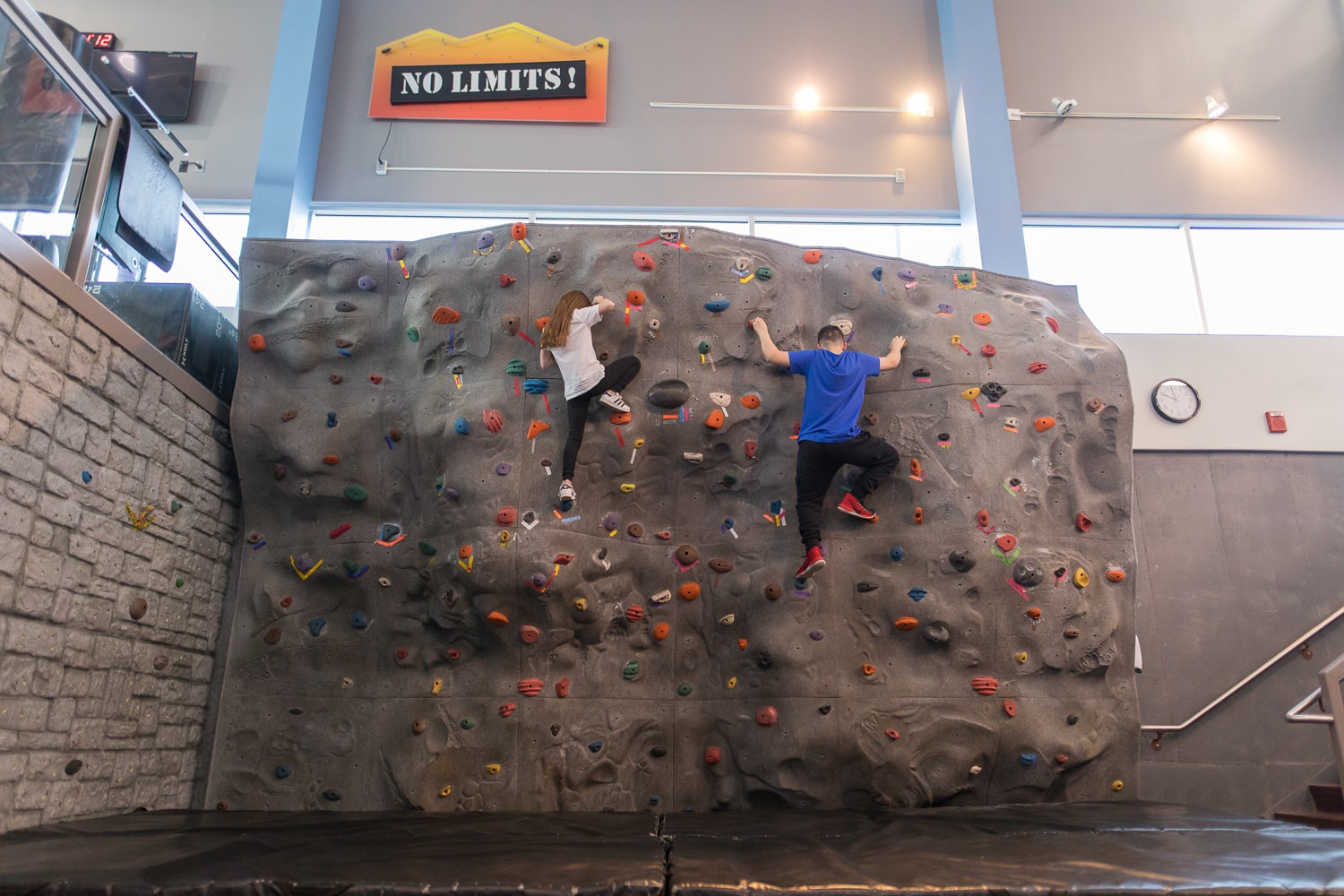 Kids climbing indoor rockwall at Salem gym. 